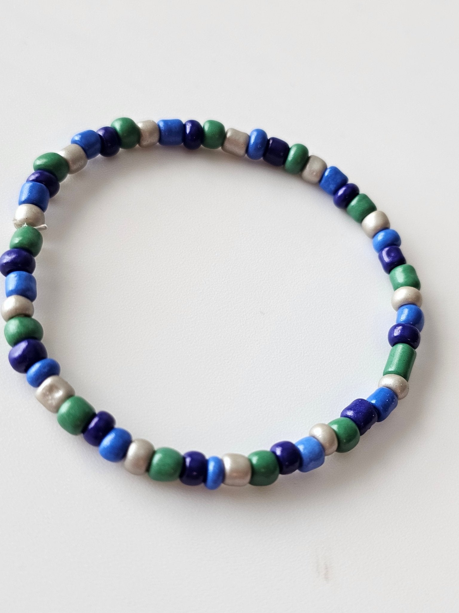 Stretchy Bead Bracelet: Blue, Green, and Silver beaded bracelet on white background - Main Street Collective