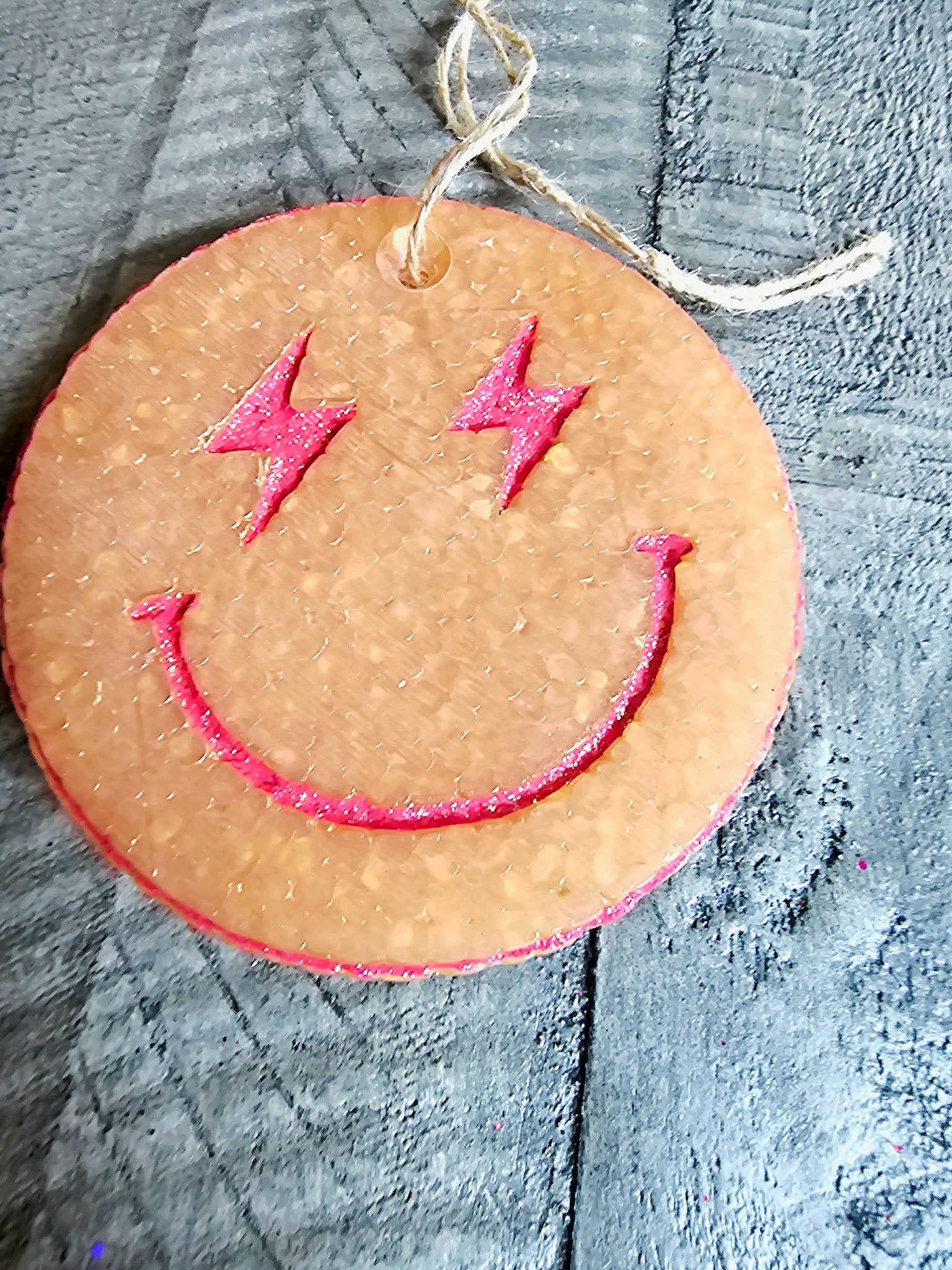 Smiley Face Car Air Freshener - Handmade Aroma Bead Car Freshie by Main Street Collective, with pink lightning bolt eyes and a smile.