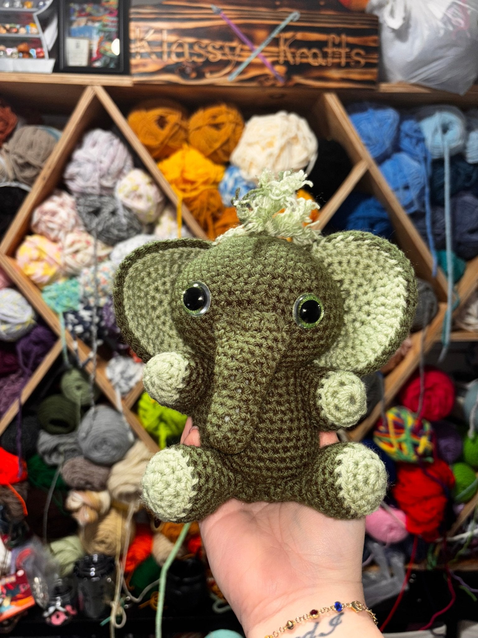 Handmade crocheted green elephant toy "ELI THE ELEPHANT" by Main Street Collective. Amigurumi elephant.