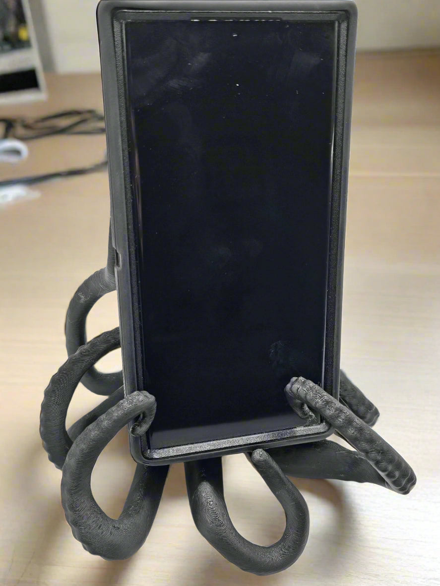 Tween Space 3D printed octopus phone holder gripping a smartphone – Mississippi handmade gift