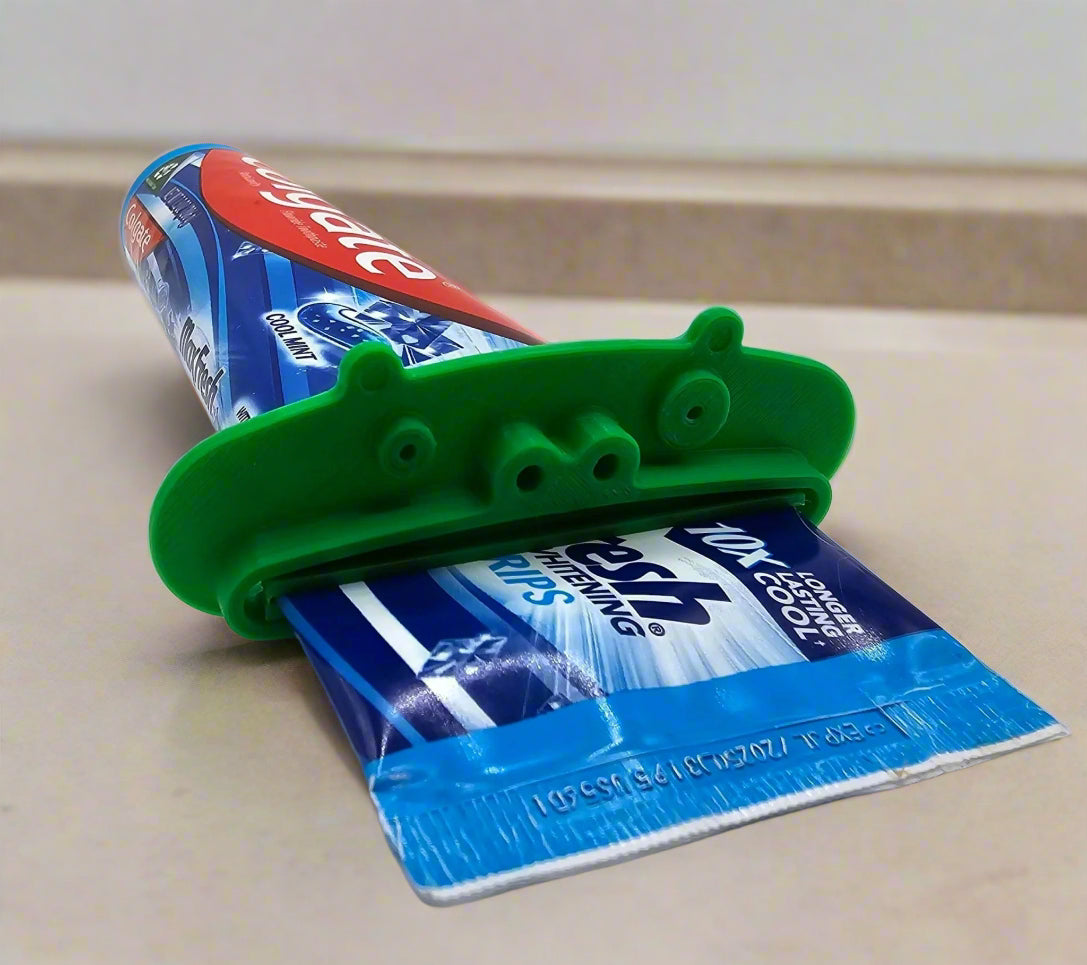 Close-up of an animal-shaped toothpaste pusher squeezing a tube – Mississippi handmade gifts