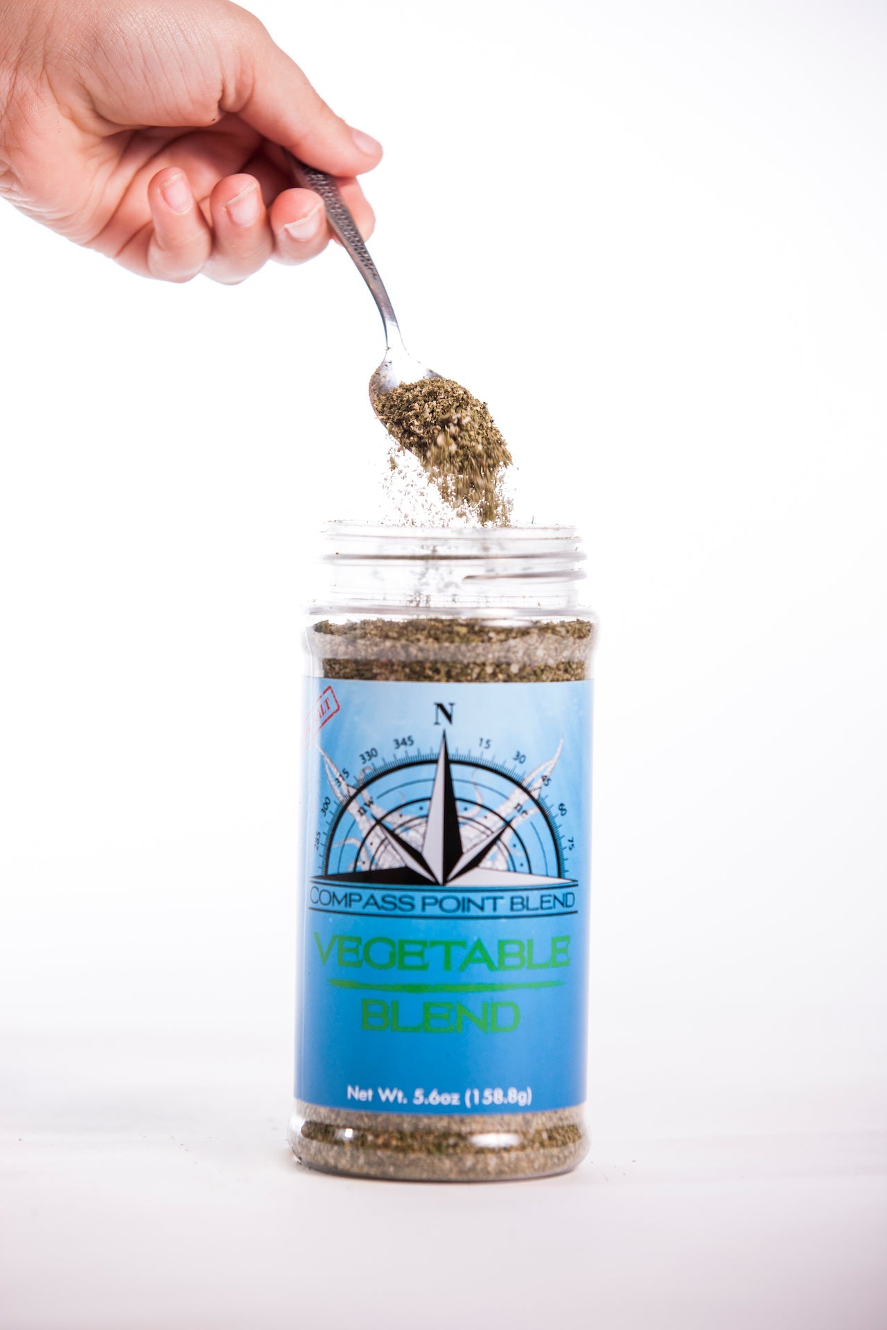 Compass Point Vegetable Blend Spice Being Spooned. Gourmet vegetable seasoning blend for cooking.