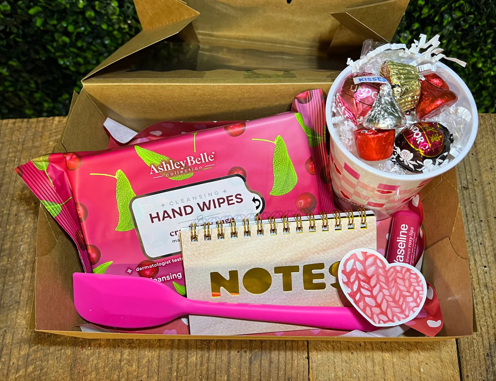 Valentine's Day gift box: hand wipes, notepad, pink spatula, lip balm & candy cup. "Main Street Collective's 'A Bit of Everything' box"
