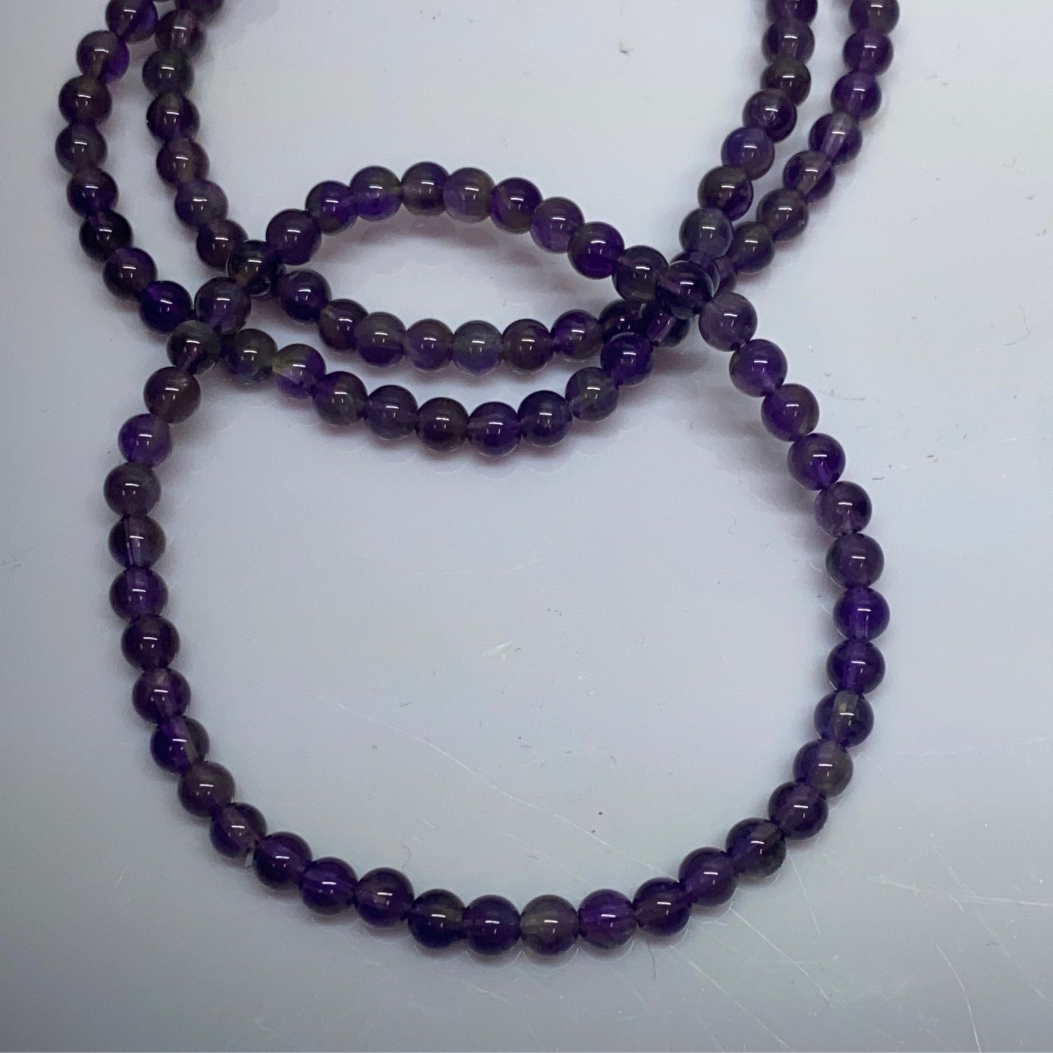 Handmade Amethyst bracelet with 4mm purple gemstone beads from Hands of Earth Energy


