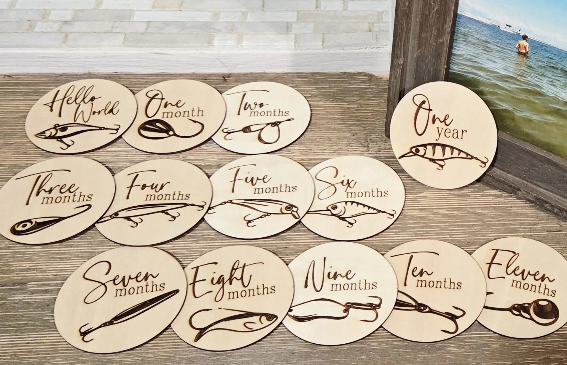 Baby milestone discs with fishing lure designs. Wooden photo props for baby's first year.