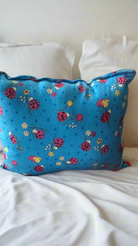 R.H.D.C. elegant throw pillow on a neatly styled bed – bedroom home décor upgrade.
