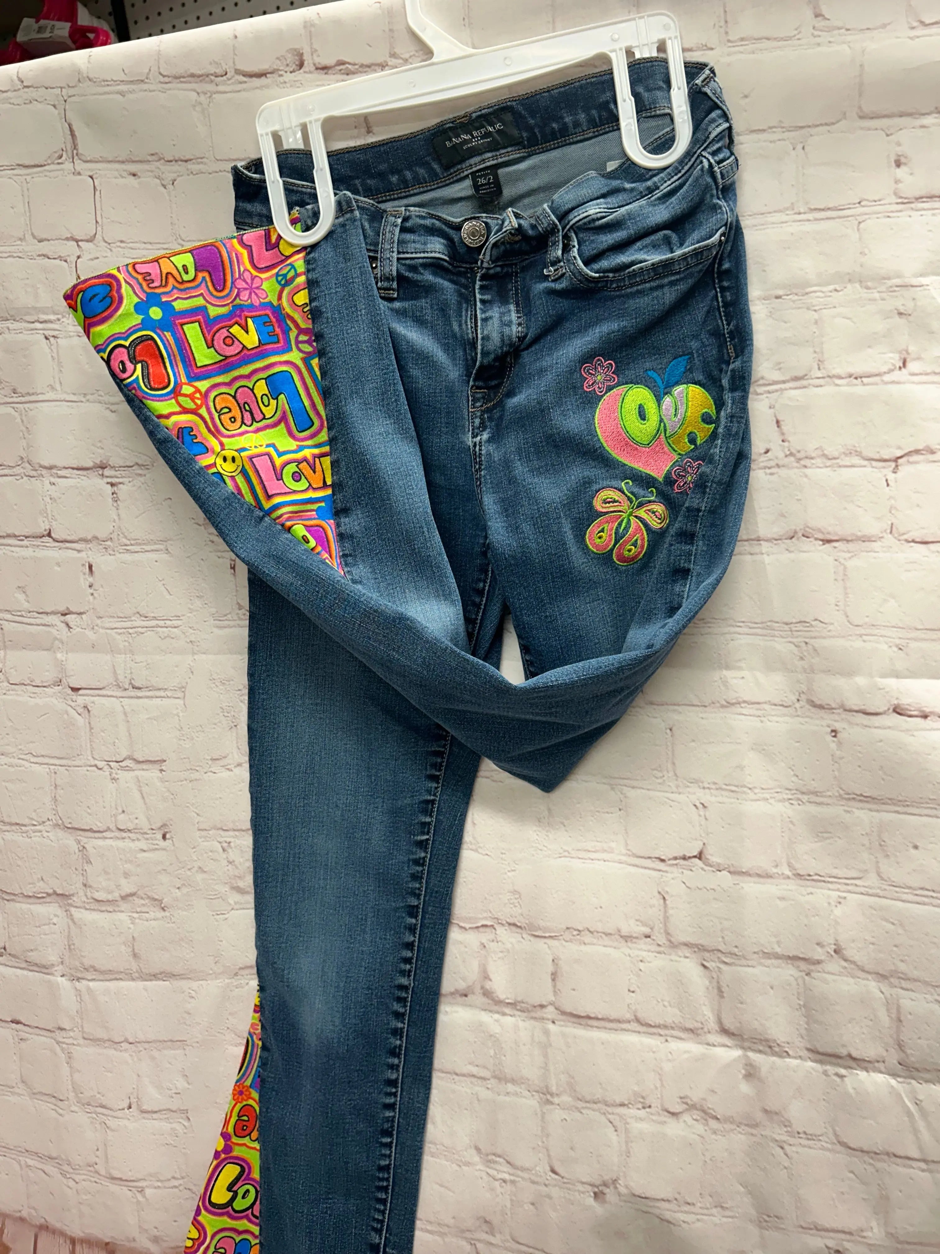 Banana Republic Upcycled Boho Flare Jeans Size 26/2. One-of-a-kind design with colorful Love pattern and embroidered details.