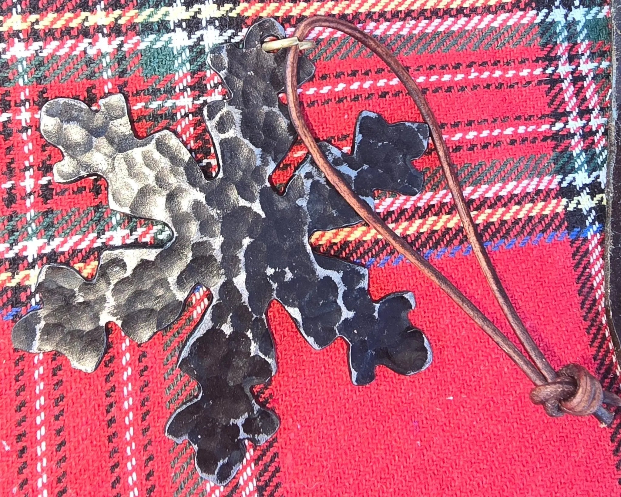 Hand-Forged Metal Snowflake Christmas Ornament on Red Tartan Fabric - Main Street Collective Holiday Decor