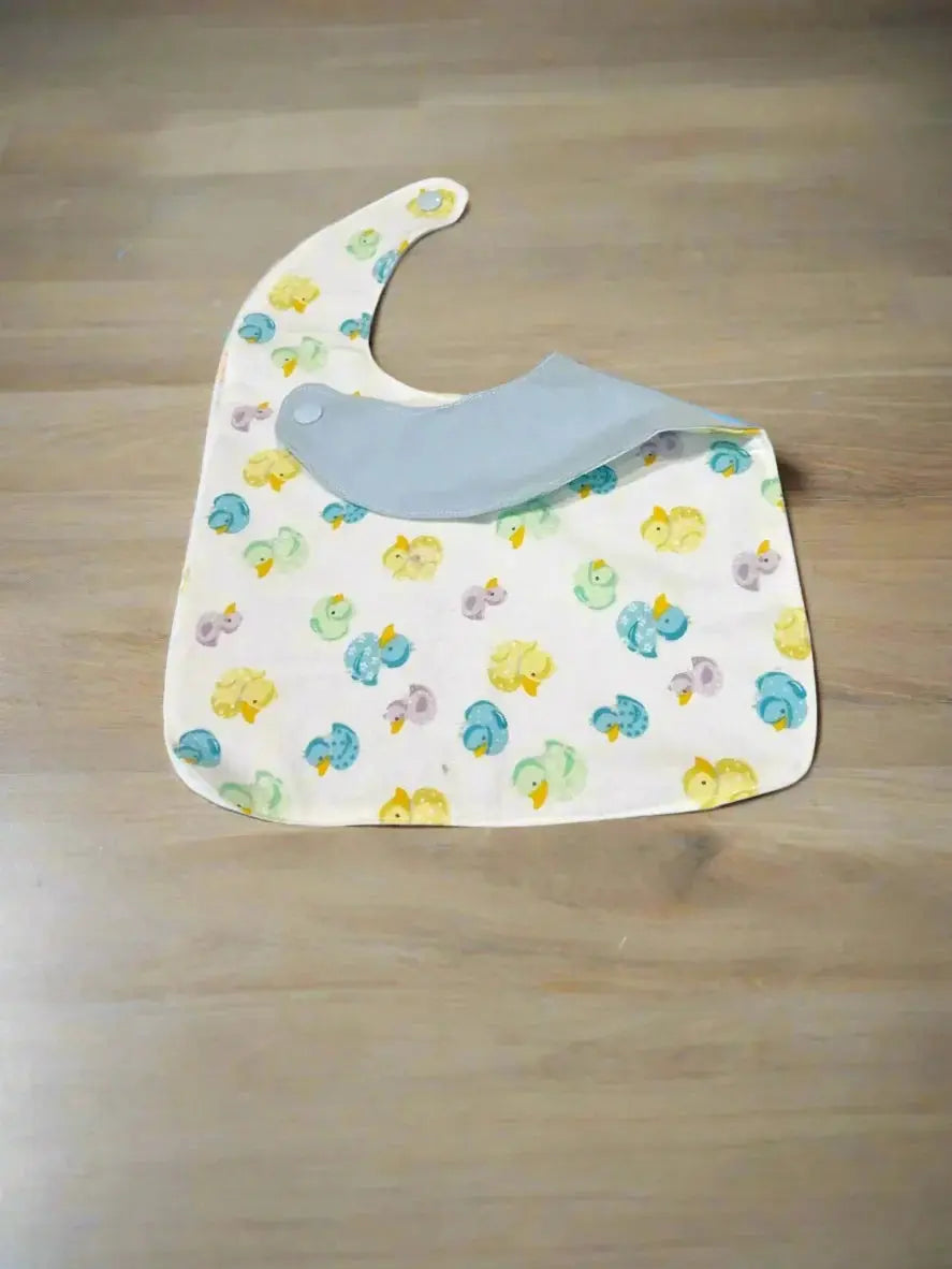 Handmade baby bib with duck pattern, soft flannel cotton. Customizable & personalized baby gift idea.