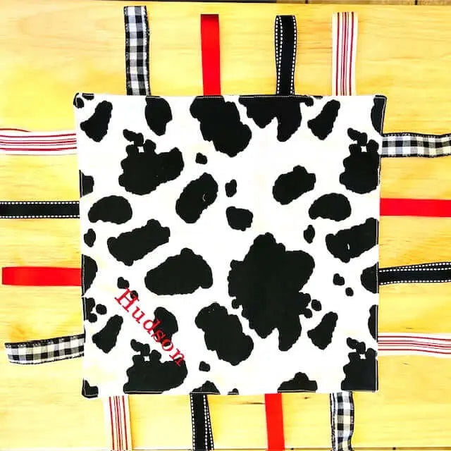 Cow Print Taggy Blanket: Personalized Sensory Toy, Handmade Baby Gift, Customizable Crib Toy