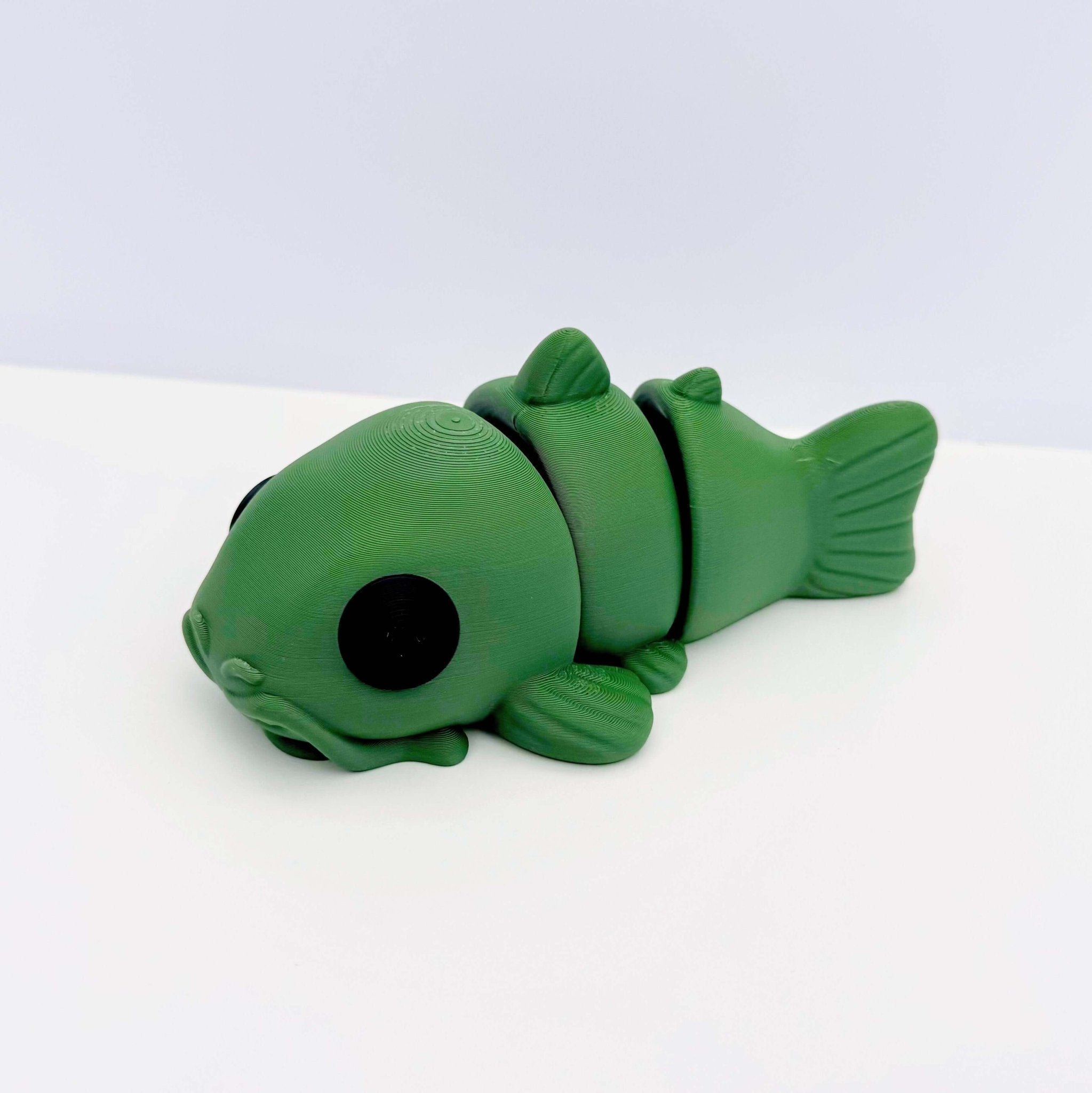 Green 3D printed catfish fidget toy. Sensory & stress relief for kids and adults. Toy catfish with joints.