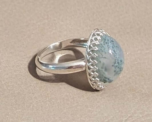 Close-up of Moss Agate gemstone with green and blue inclusions – handmade jewelry from Mississippi.