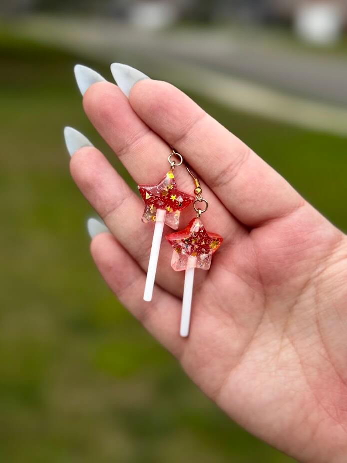 Handmade fairy earrings: Red resin star candy lollipop earrings. Whimsical fairycore jewelry by Mushroom Lady Co.