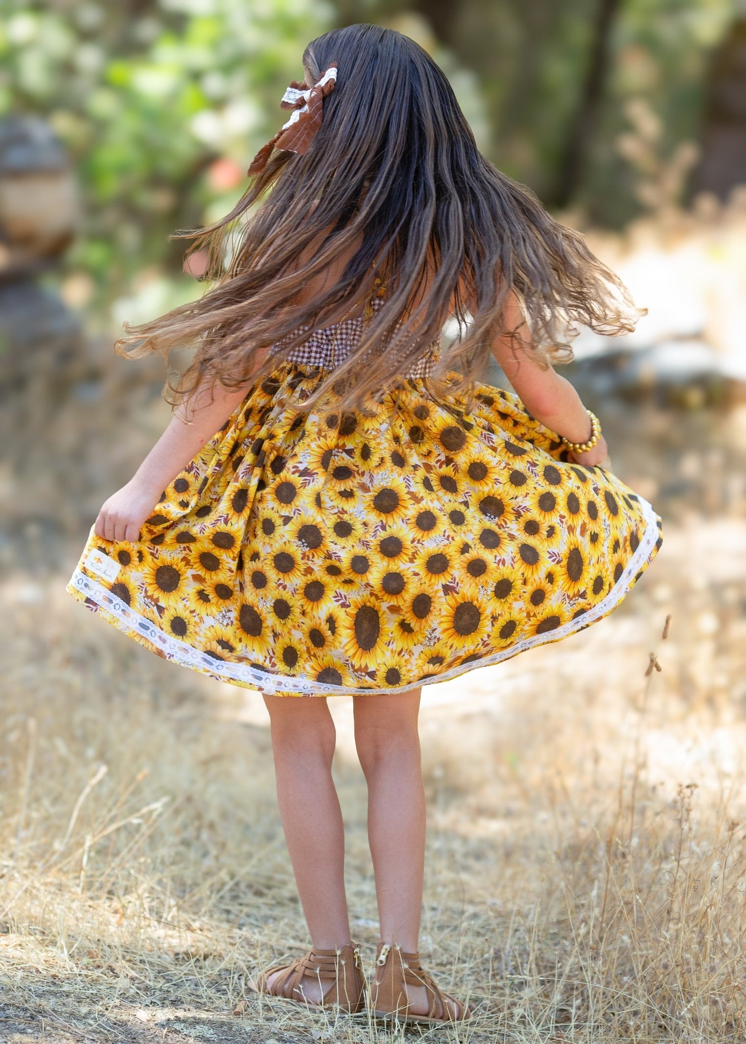 Girl in Sunflower Dress Twirling by Main Street Collective, Flowy Yellow Summer Dress