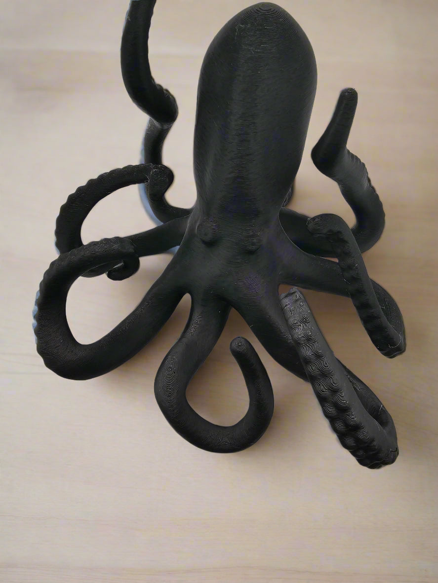 The Tween Space octopus phone holder displayed on desk – Mississippi handmade gift
