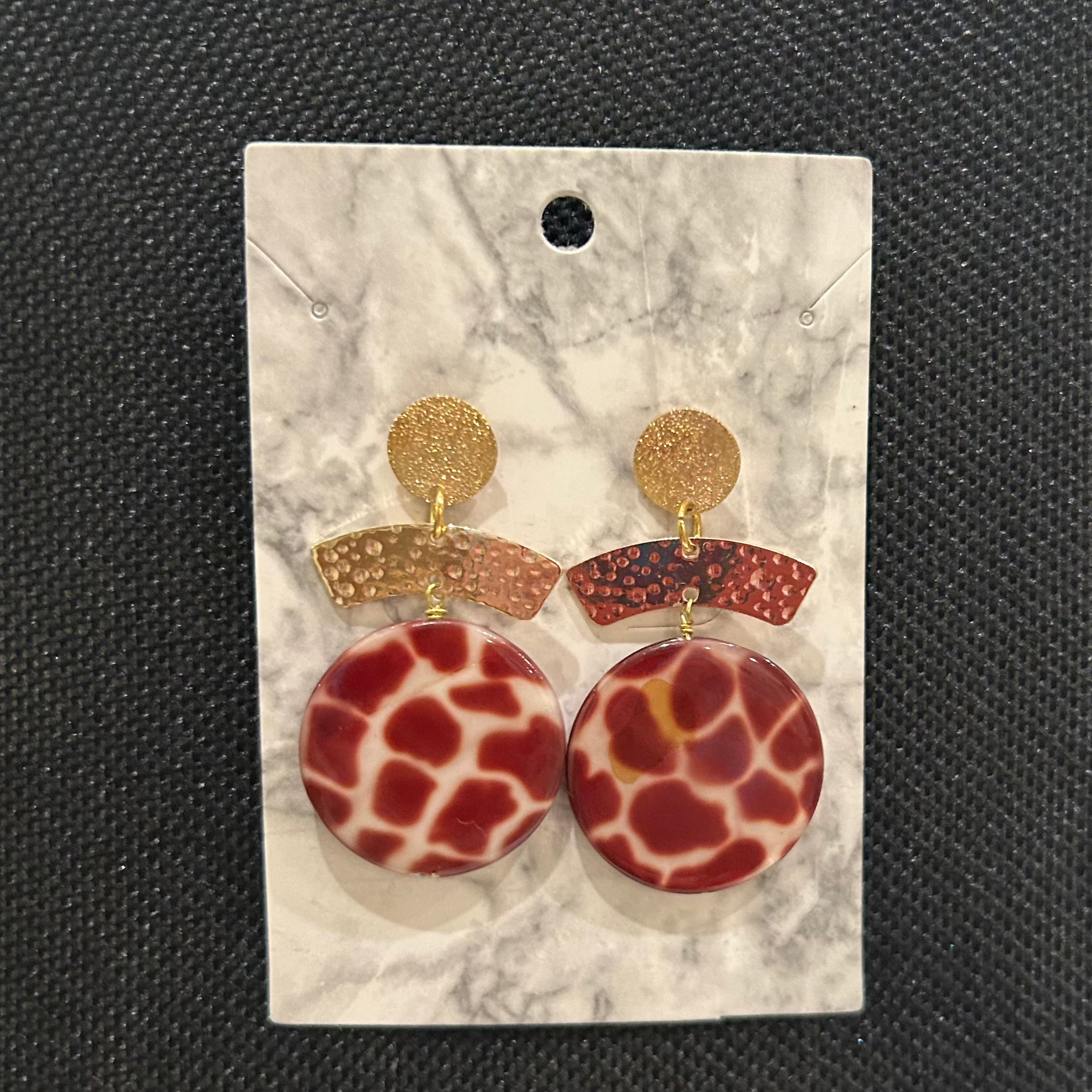 Handmade earrings with gold round studs, hammered half-moons, and dark red and cream leopard medallions by Soulful Designs