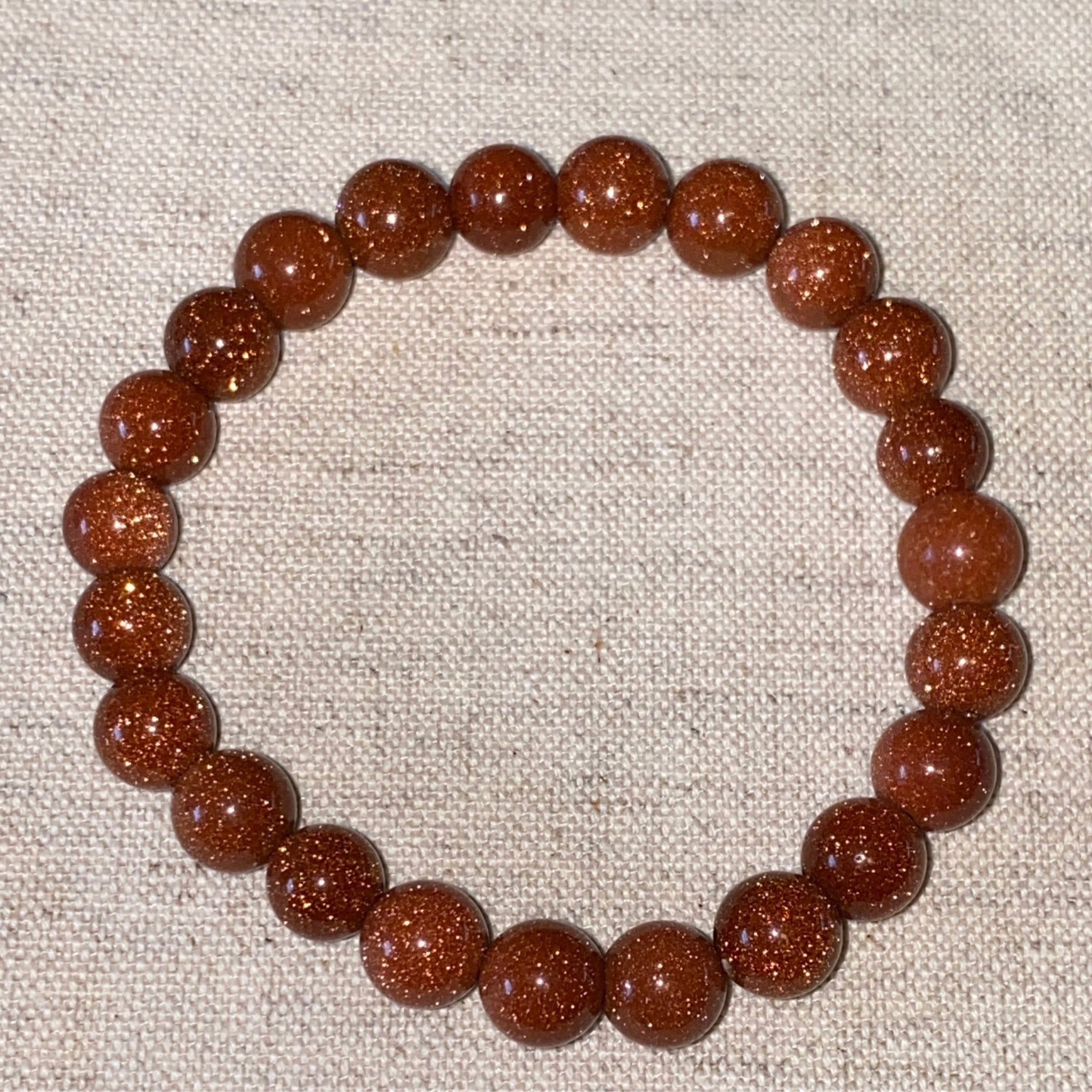 Handmade Goldstone bracelet with 8mm sparkling copper-toned beads from Hands of Earth Energy