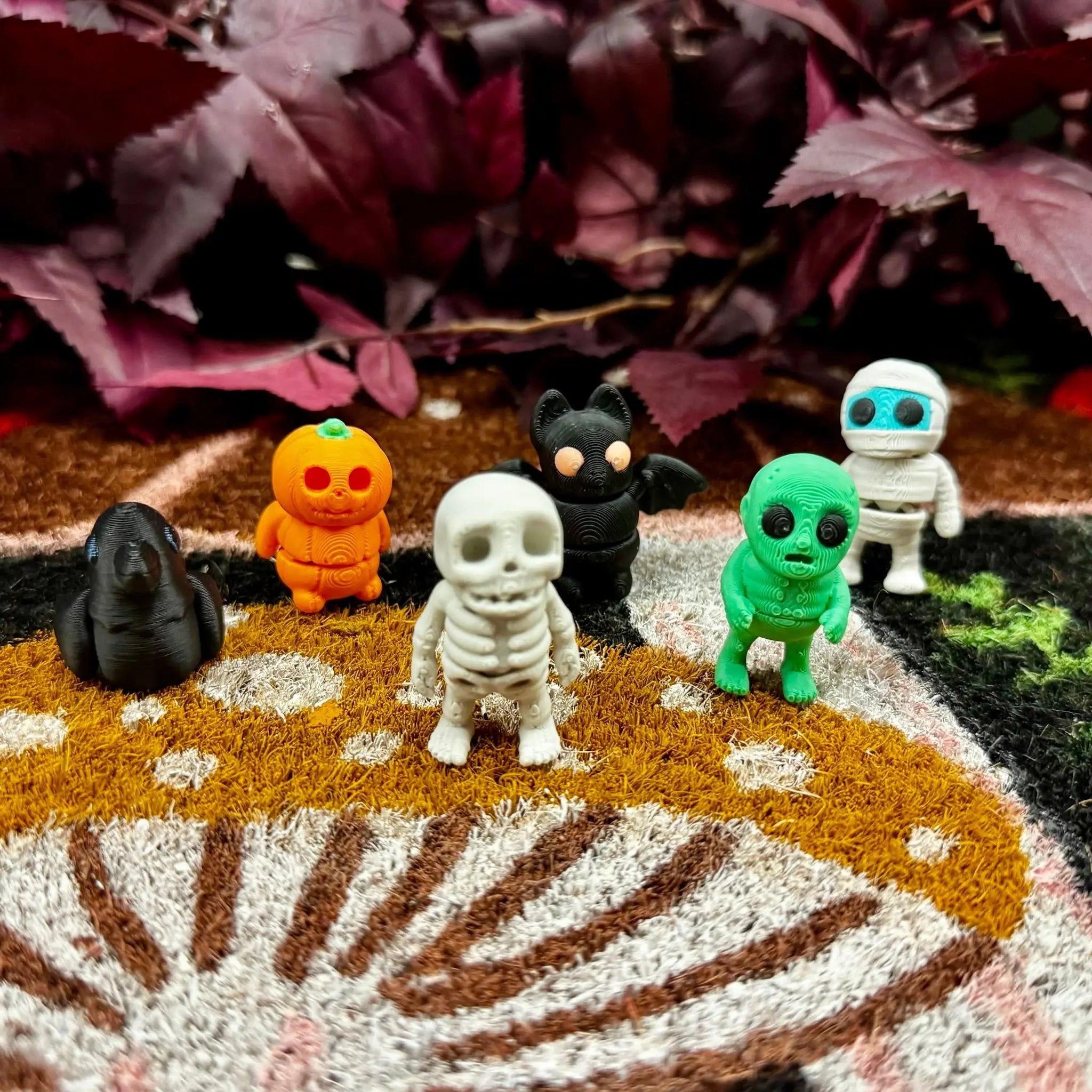 3D printed Halloween fidget toys: bat, crow, mummy, pumpkin, skeleton, zombie. Spooky season decor.