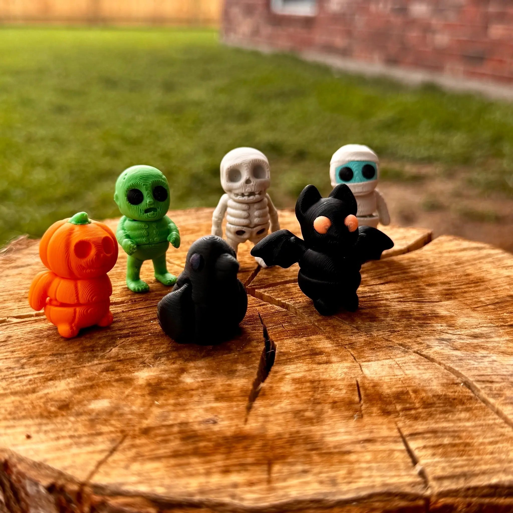 Halloween Fidget Toys: 3D Printed Pumpkin, Zombie, Skeleton, Mummy, Bat, & Crow Figurines on Wooden Log by Main Street Collective