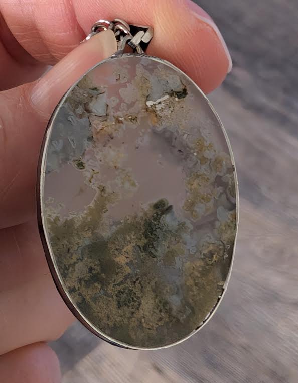 Hand-cut Moss Agate gemstone showing natural inclusions, artisan jewelry made in Mississippi