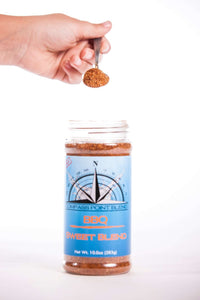 Hand holding a spoonful of Smoky Sweet BBQ Blend showing full jar and seasoning texture – Compass Point Blends