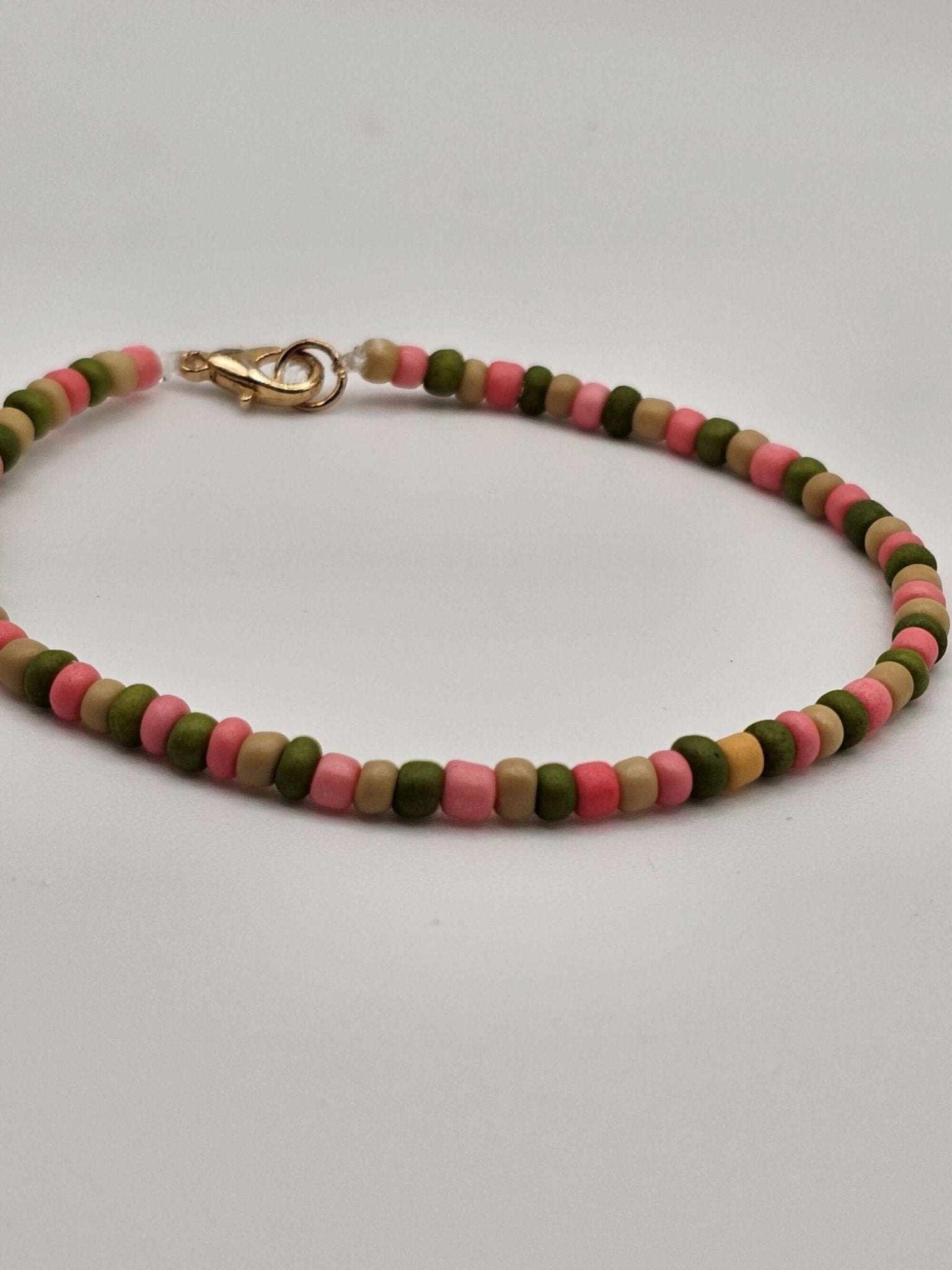 Close-up of colorful mini beads on The Tween Space Pink & Green Tiny Bead Bracelet – Mississippi handmade gifts