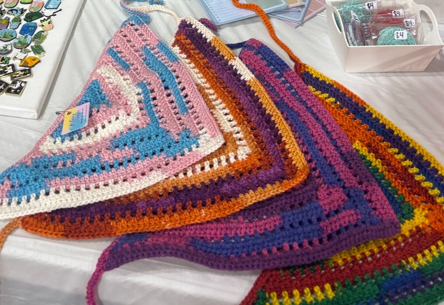 Handmade crocheted bandana in bold primary colors: red, blue, yellow, and white.