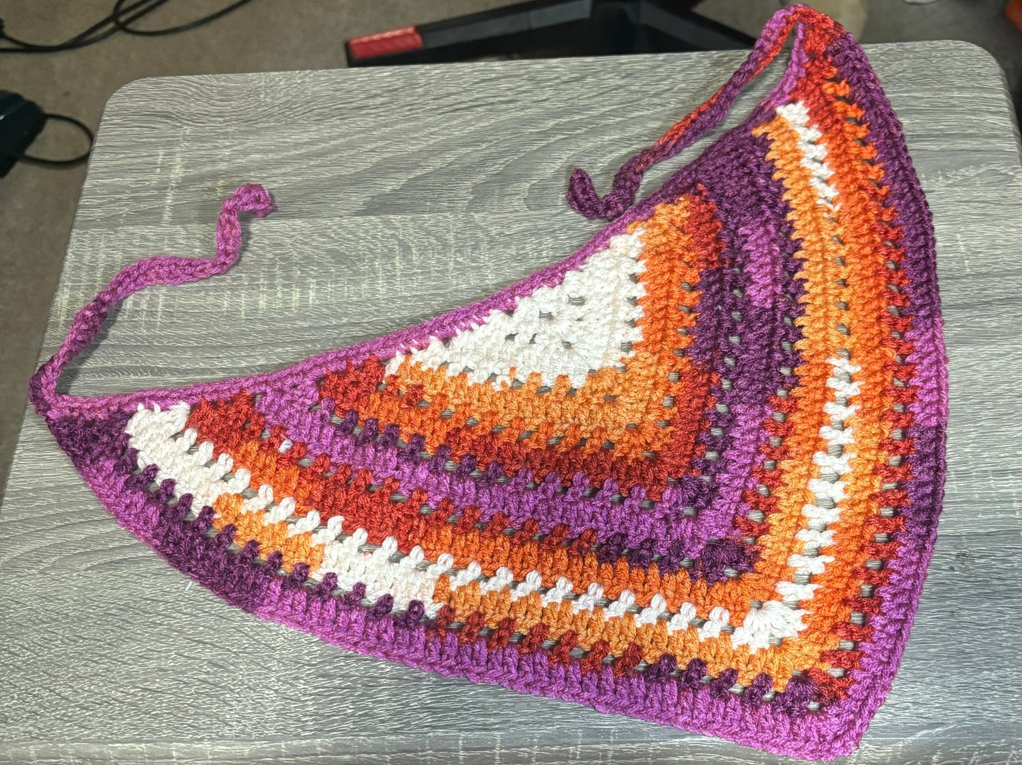 Handmade crocheted bandana in earthy tones, including brown, olive, mustard, and cream.