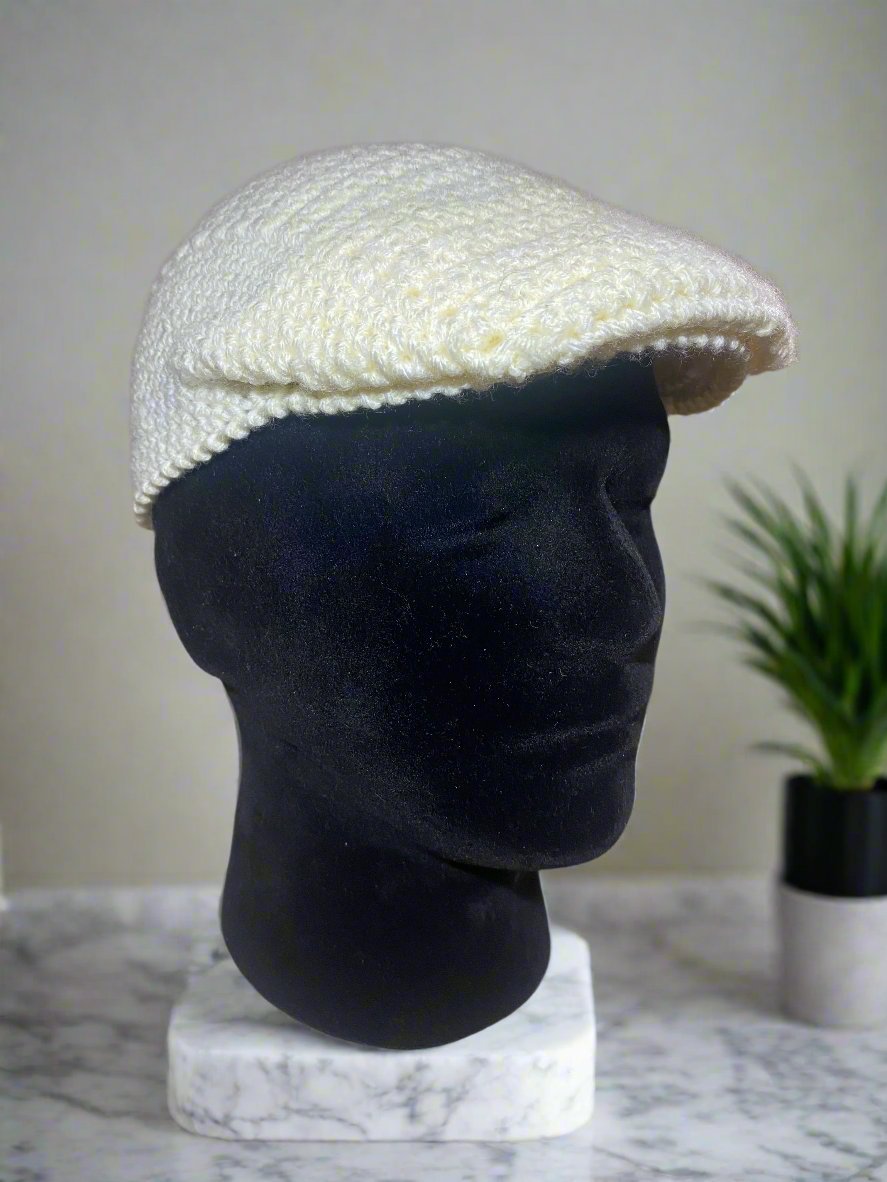 Crochet Newsboy Cap: Handmade cream-colored Kangol style hat on display. Main Street Collective.