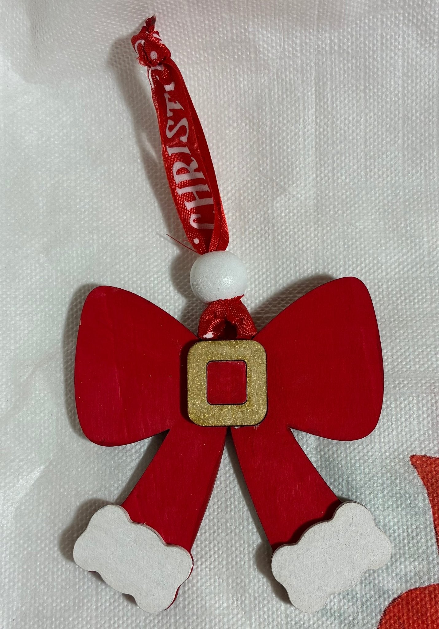 Hand-painted wooden Christmas ornament: Santa's bow tie. Festive Christmas decor.