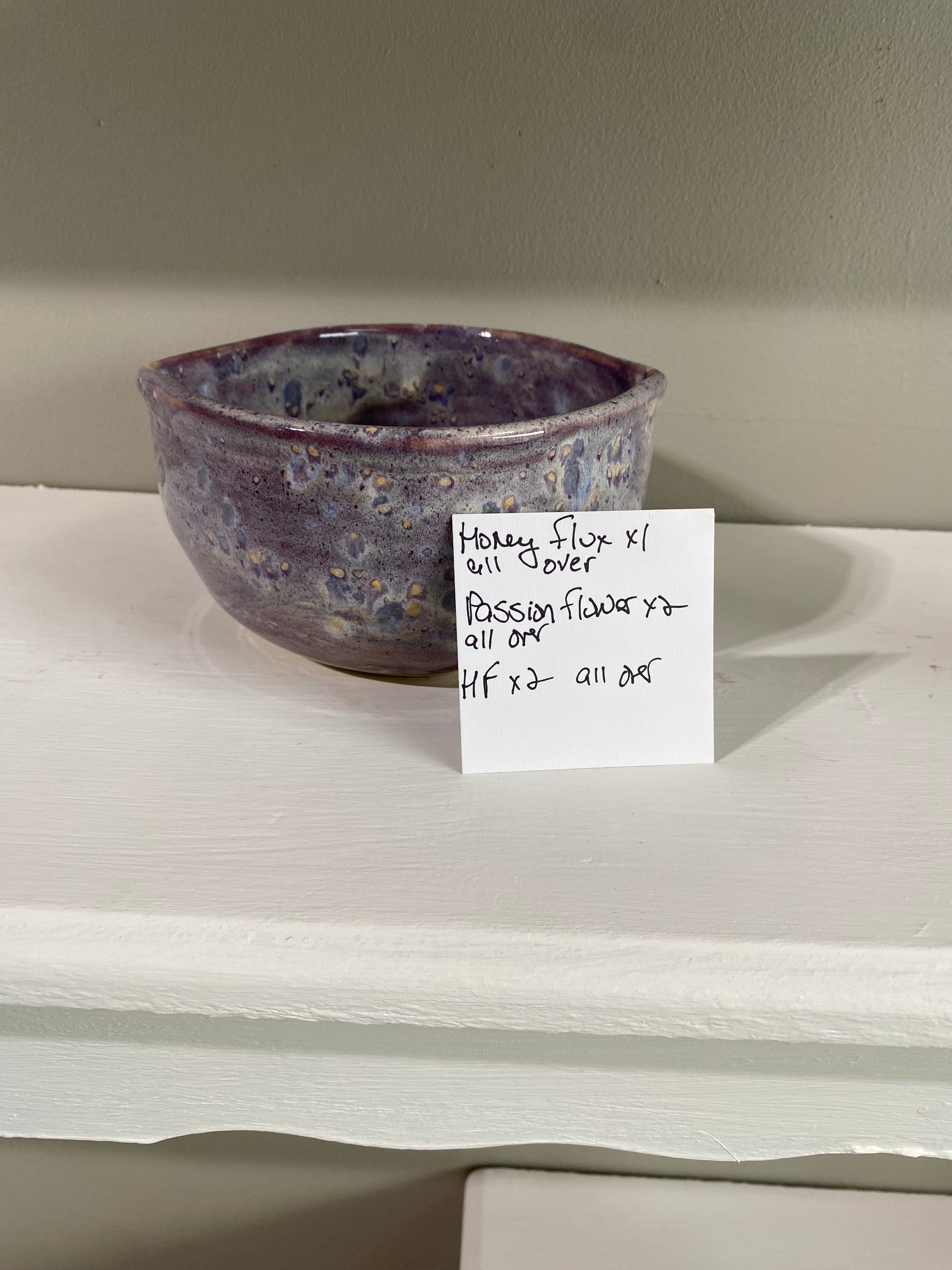 Purple speckled pottery bowl with glaze recipe card. Handmade from Main Street Collective pottery studio.