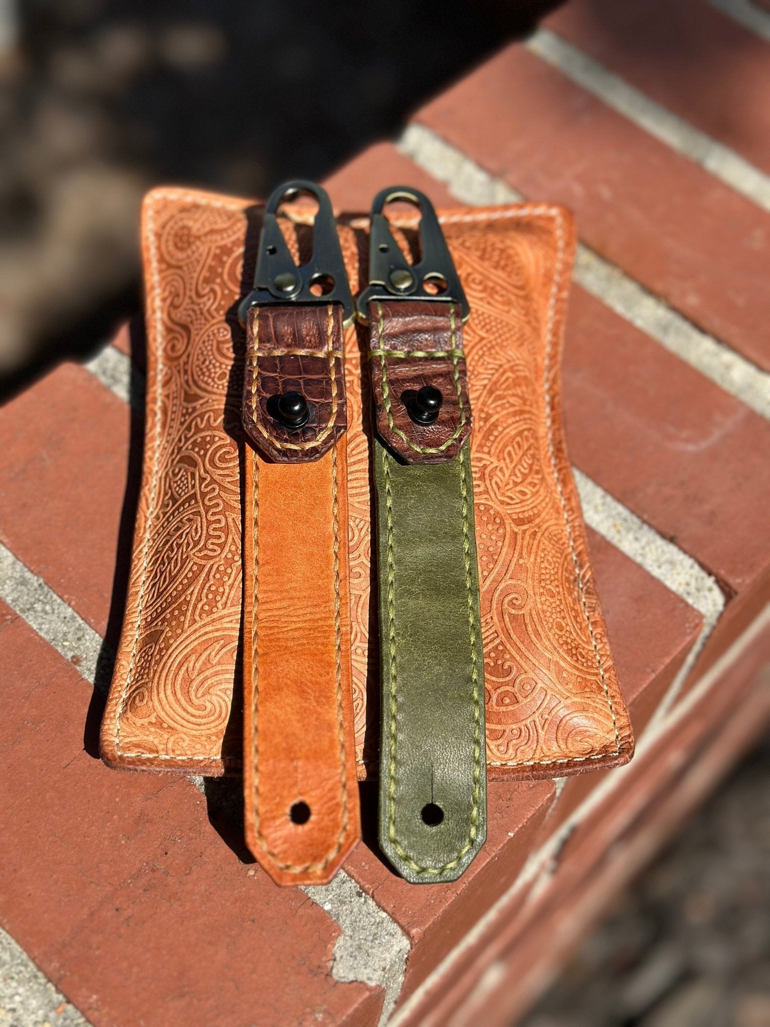 Handmade leather keychains in orange & green on Main Street Collective wallet. Durable full-grain leather, metal hardware.