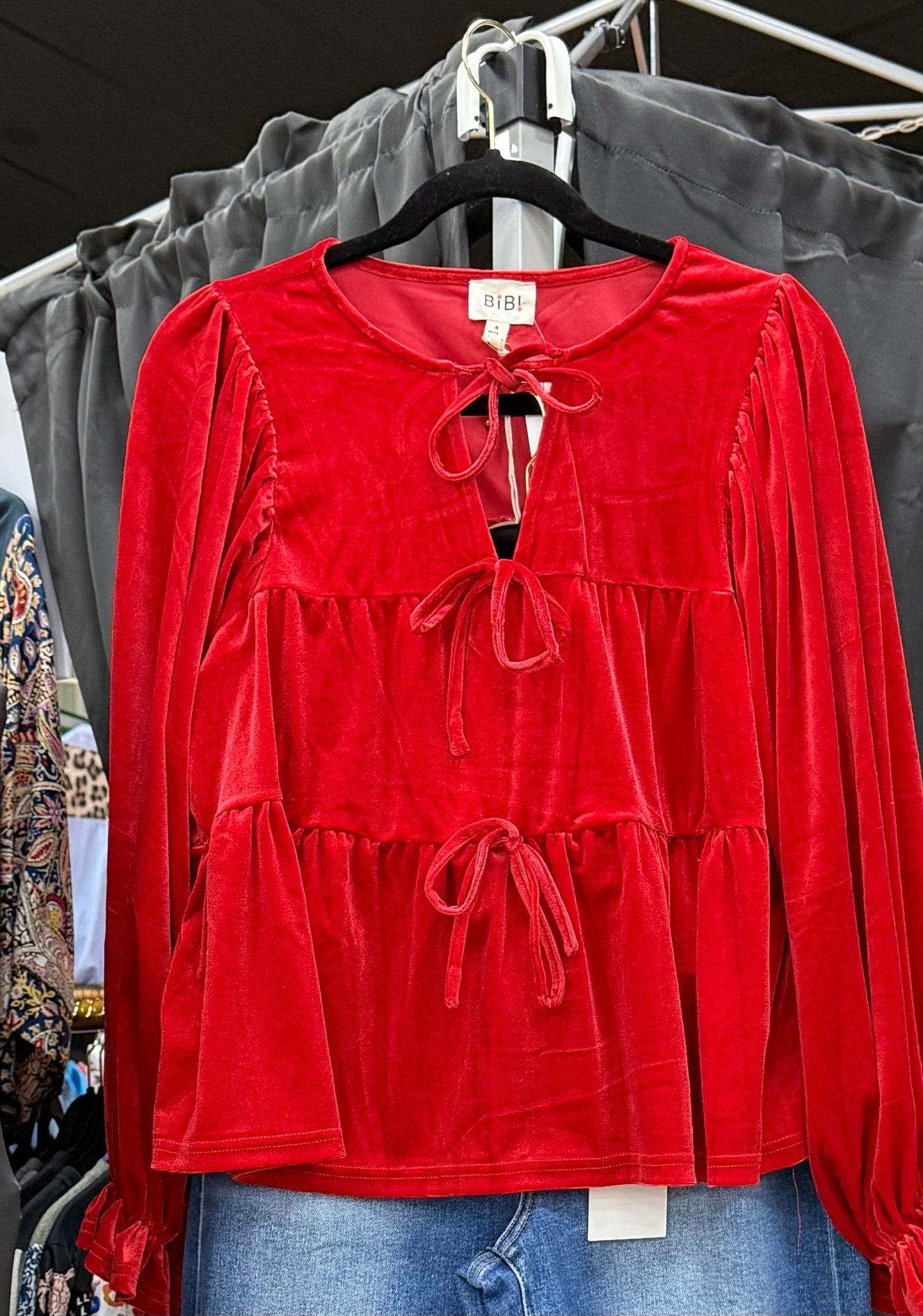 Red Velvet Bow Blouse from Main Street Collective: Long Sleeves, Tiered, Ruffled, Festive & Stylish. Christmas Holiday Outfit Idea