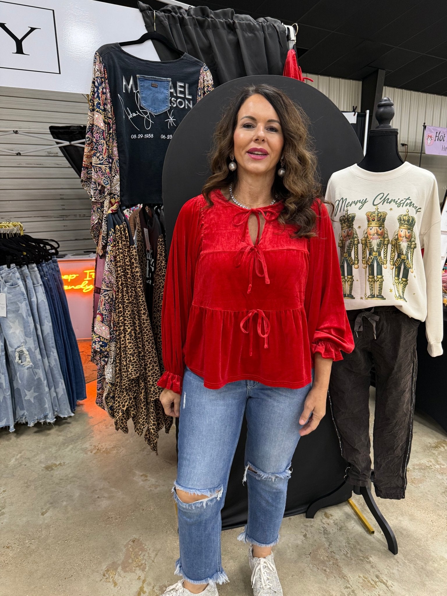 RED VELVET BOW BLOUSE on Woman at Main Street Collective. Trendy Red Blouse & Ripped Jeans, Shop Now!