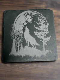Laser engraved slate coaster – howling wolf design on rustic slate, part of wildlife coaster set by Faithful Woodworks.