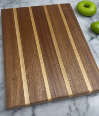 Mississippi handmade gift – angled photo of 13.5x10.5 sapele and maple cutting board by Faithful Woodworks, showing rich wood grain and handcrafted detail.
