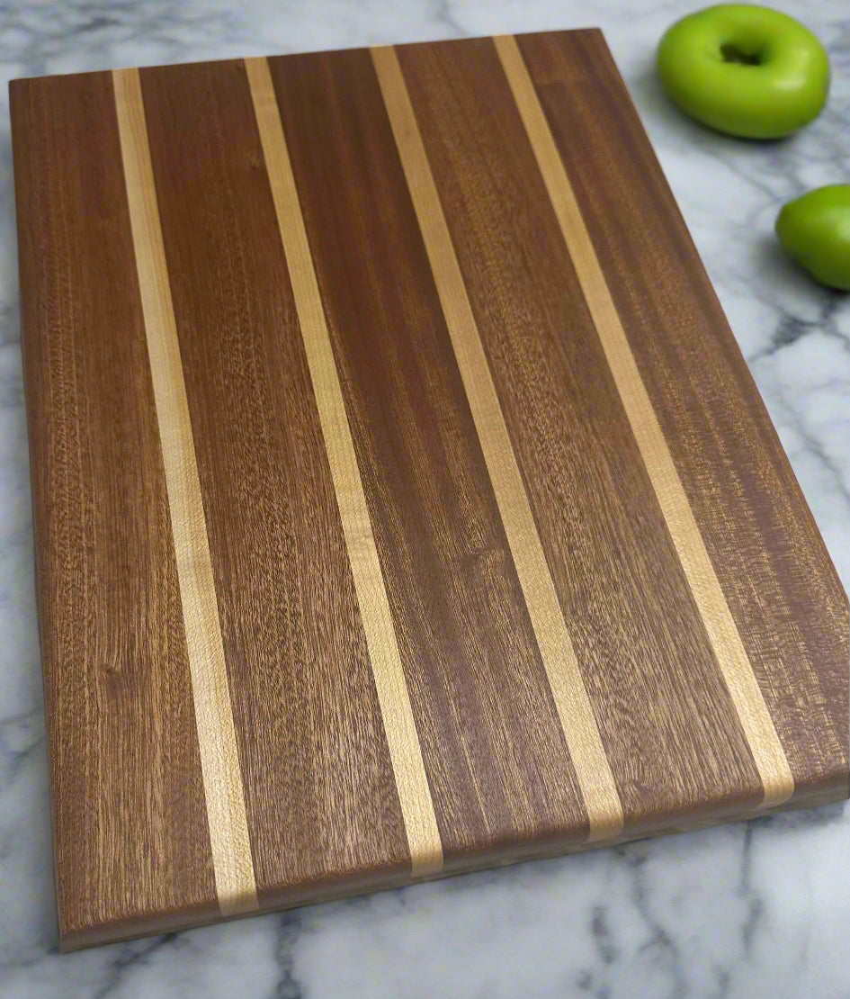 Mississippi handmade gift – angled photo of 13.5x10.5 sapele and maple cutting board by Faithful Woodworks, showing rich wood grain and handcrafted detail.