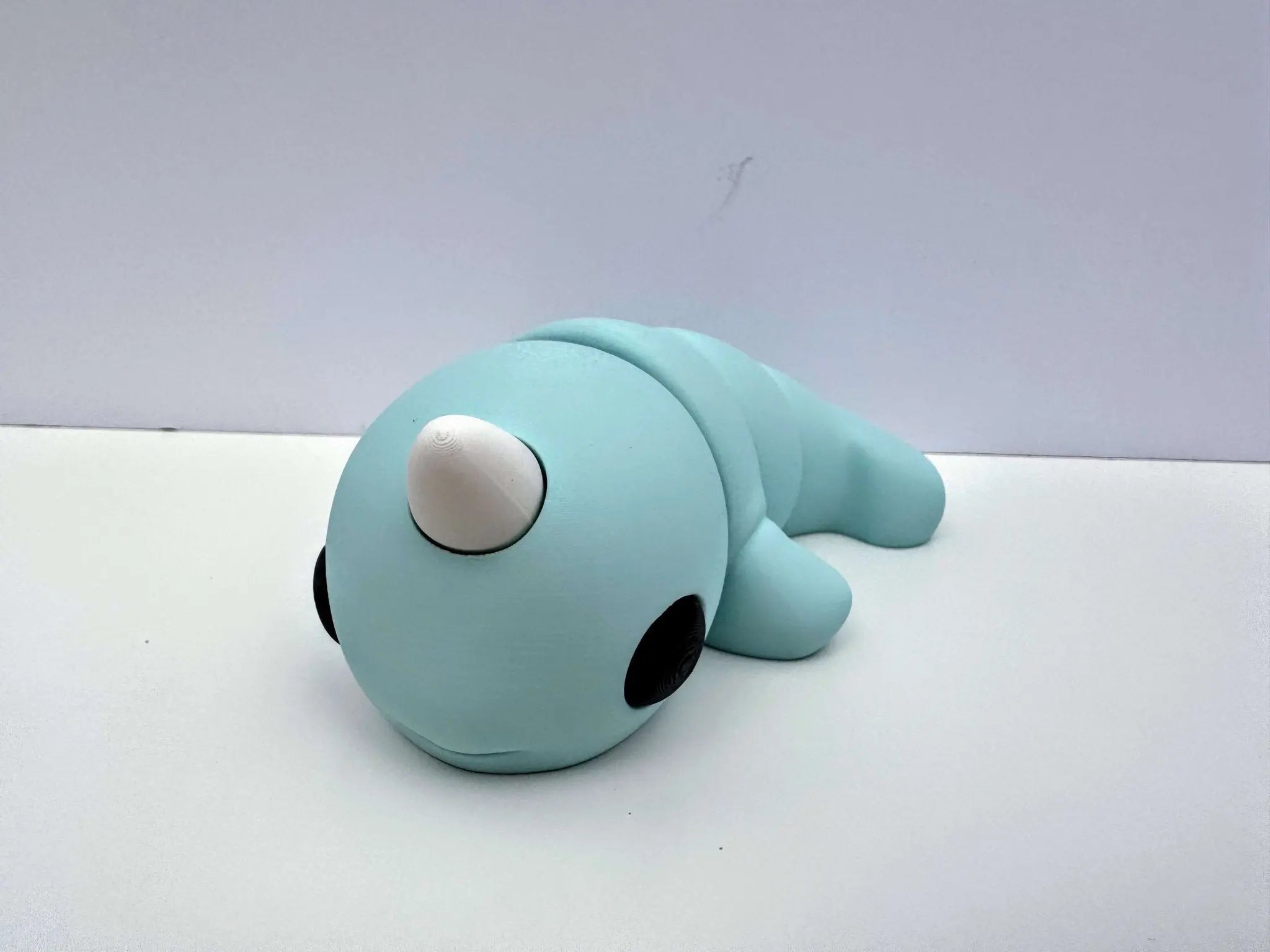 Light blue narwhal fidget toy, 3D printed sensory toy by Mushroom Lady Co. Mississippi handmade for tactile learning.