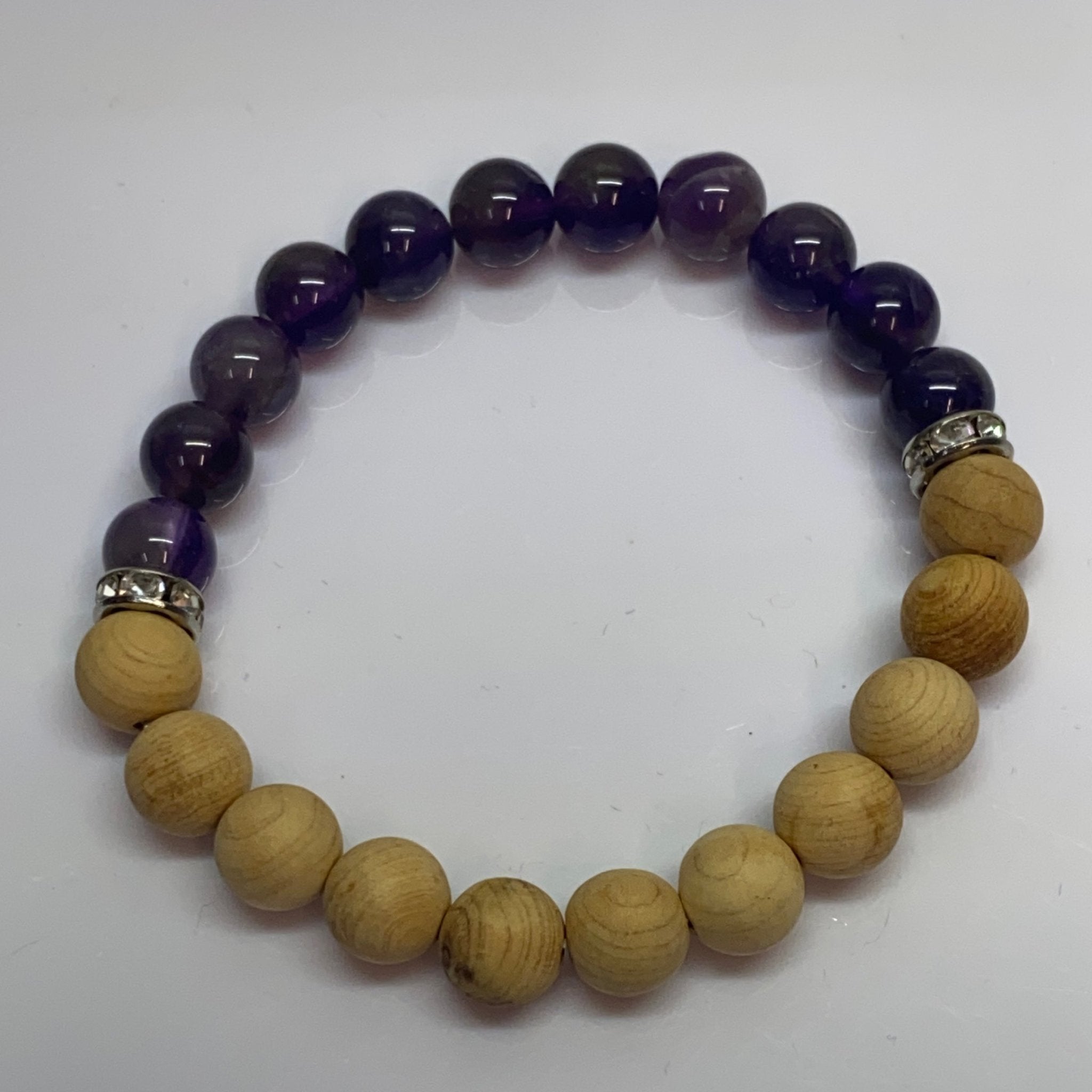 Handmade bracelet with 8mm Amethyst stones and natural Palo Santo wood beads by Hands of Earth Energy