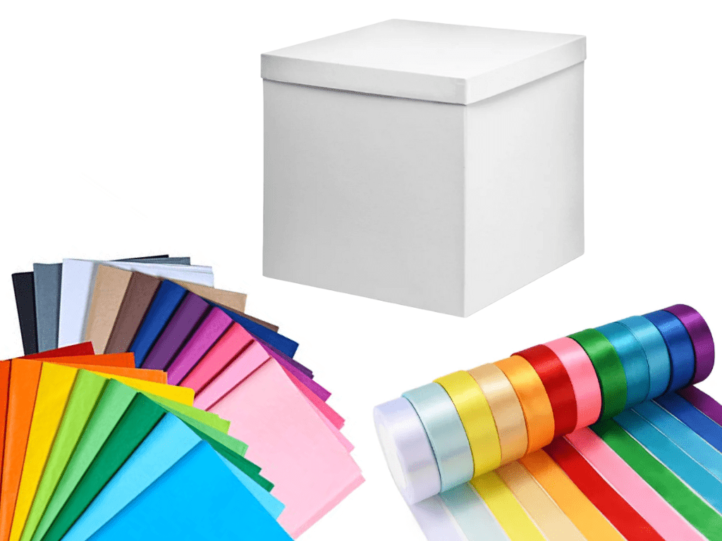 White gift box, colorful paper and ribbons for crafting or gifting. Creative packaging, presentation.