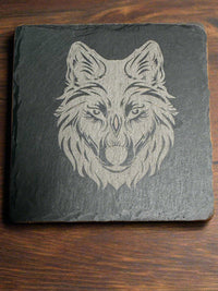 Rustic wildlife coaster – detailed engraving of wolf face on slate coaster by Faithful Woodworks.