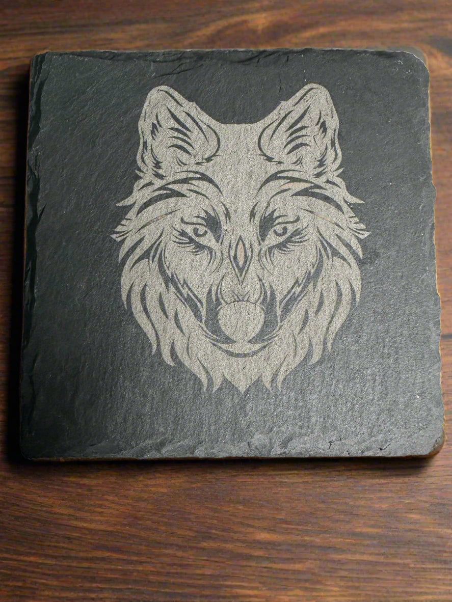 Rustic wildlife coaster – detailed engraving of wolf face on slate coaster by Faithful Woodworks.
