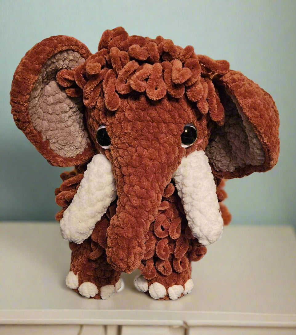 Soft handmade mammoth plush toy, perfect for cuddling.