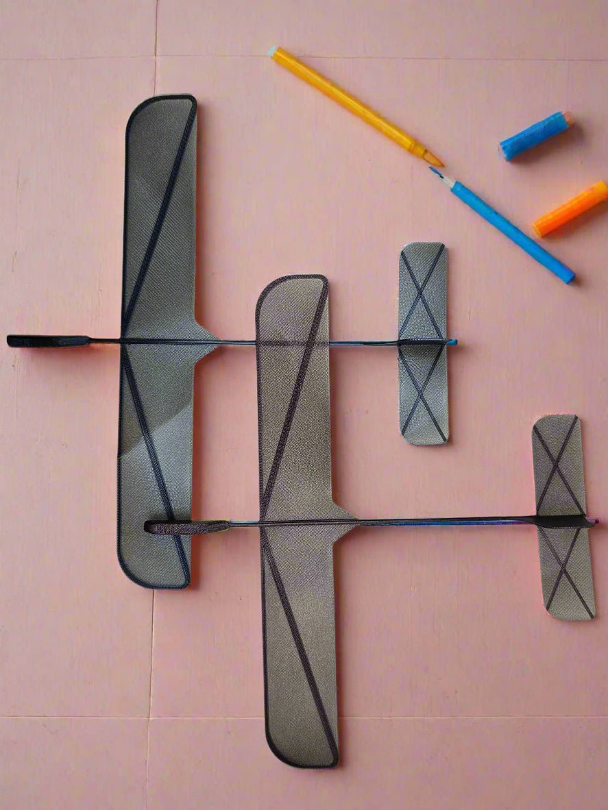 Top view of three 3D printed glider planes showing their wingspan and lightweight design.

