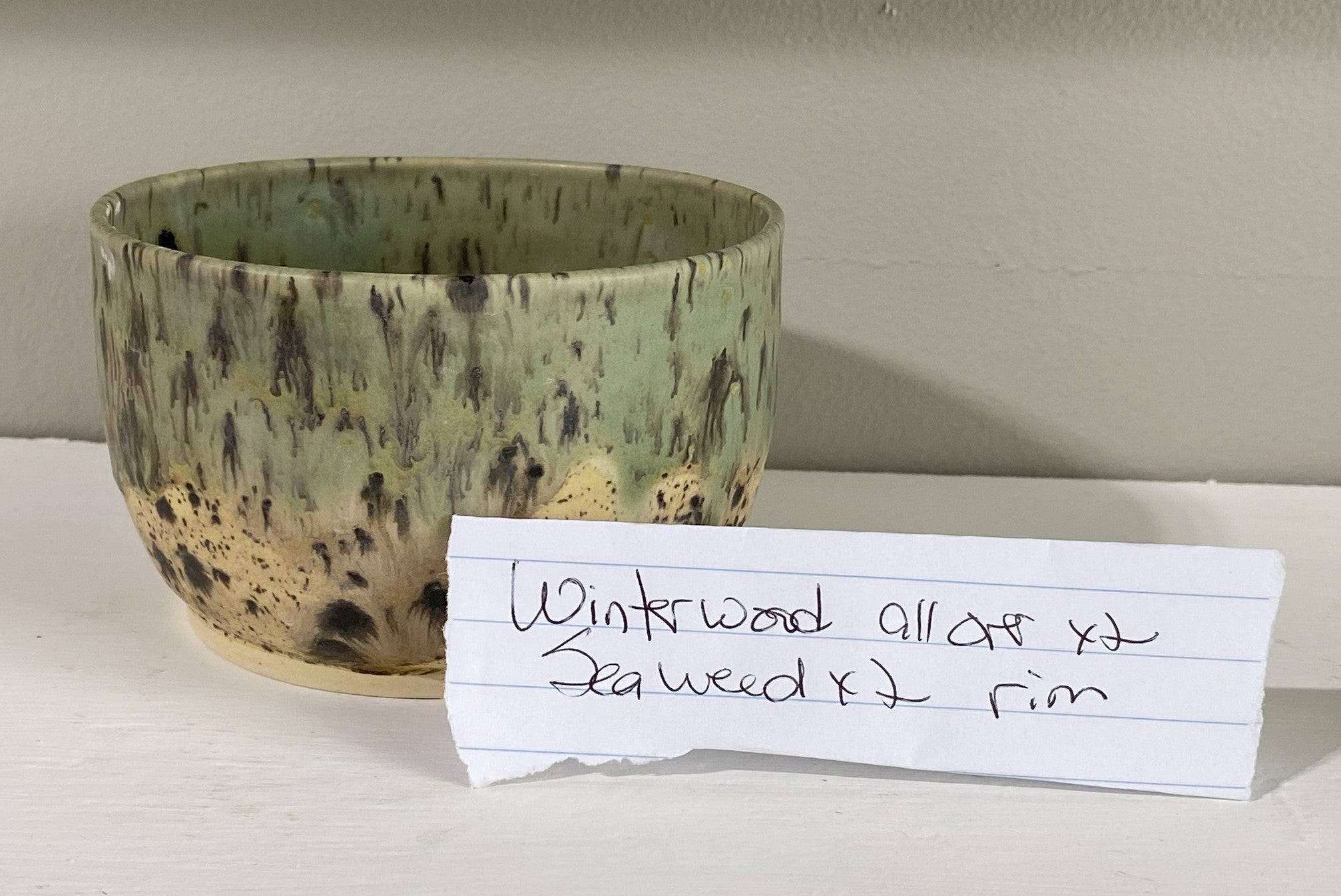 Handmade pottery cup with Winterwood and Seaweed glaze from Wheel in the Window Pottery Studio at Main Street Collective.