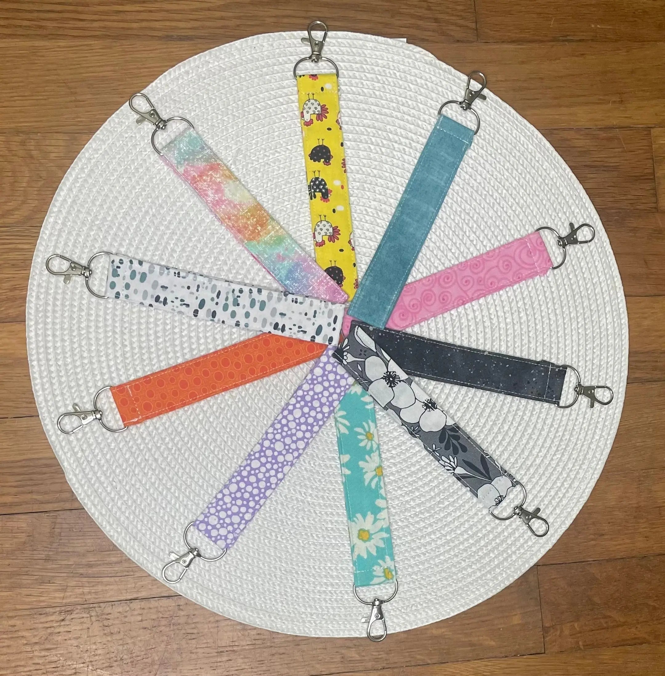 Handmade fabric wristlet keychains by Main Street Collective: colorful designs, key fobs, accessories, and keychains on display.