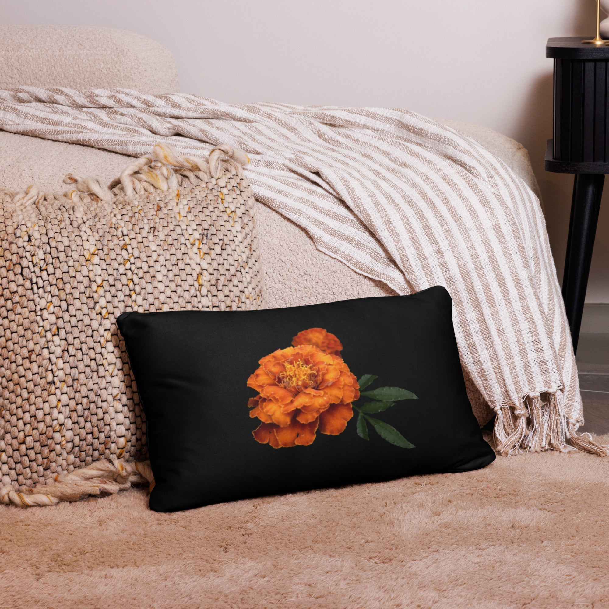 Orange Flower Pillow: Black decorative pillow with marigold flower design by Main Street Collective. Home decor accent.