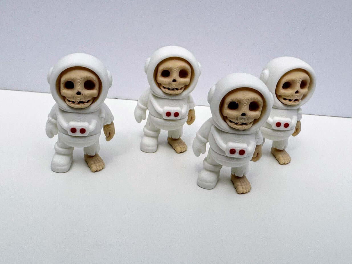 Four astronaut skeleton fidget toys from Mushroom Lady Co. 3D printed, handmade in Mississippi. Unique sensory toy.