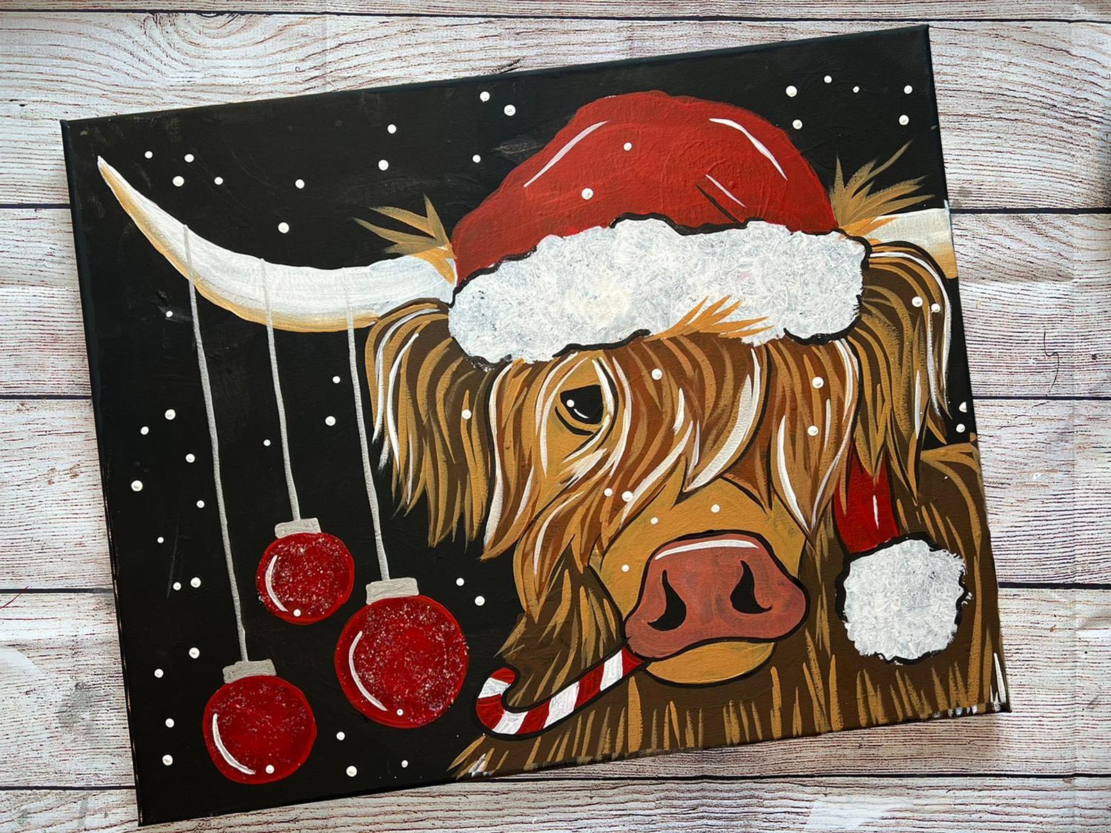 Christmas Highland Cow Painting: Adorable Cow with Santa Hat and Candy Cane Decorating Black Background With Ornaments