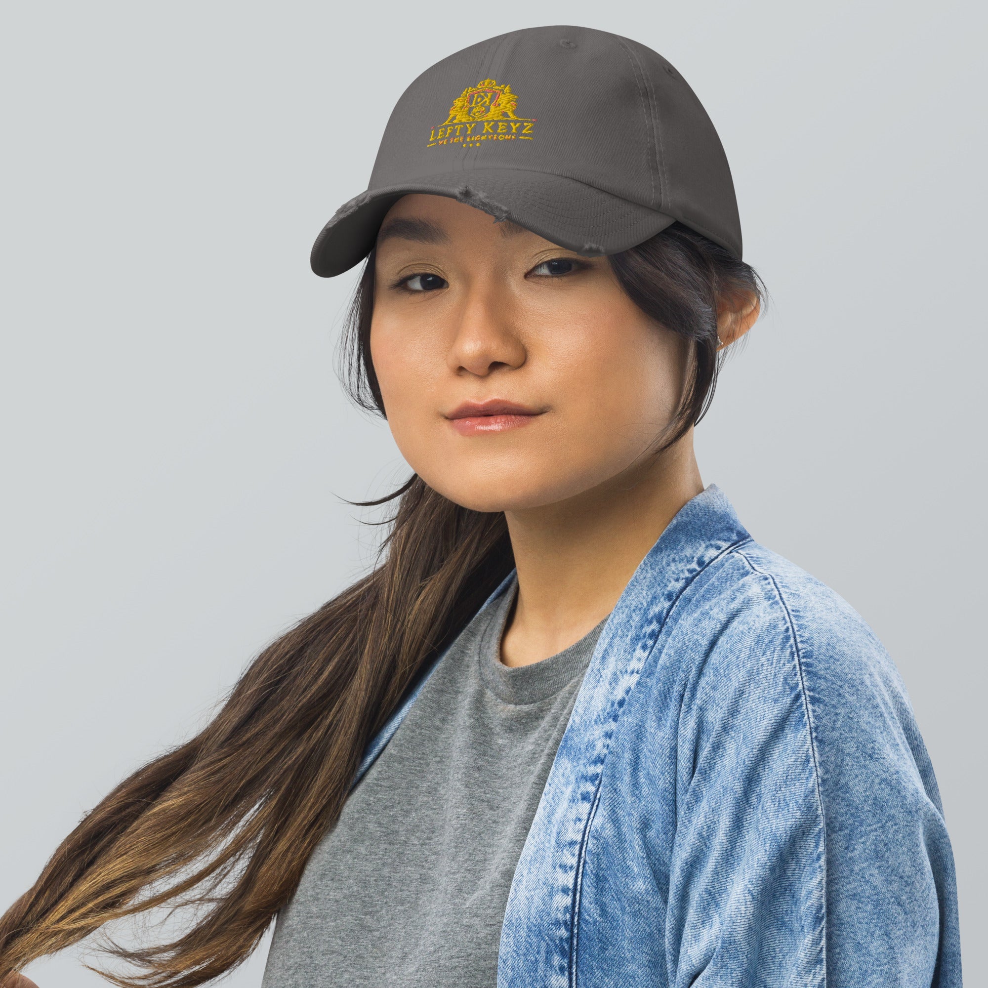 Model Wearing Lefty Keyz Distressed Dad Hat: Gray Cap, Fashionable Headwear, Casual Style.